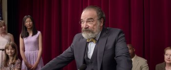 Movie still from “Wonder” (2017), directed by Stephen Chbosky – An older man in a suit and bow tie; Close Up shot, Over the shoulder angle