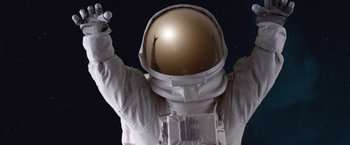 Movie still from “Wonder” (2017), directed by Stephen Chbosky – A person in a spacesuit is holding something in his hand; Medium shot, Low angle