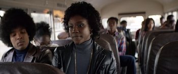 Movie still from “Woodlawn” (2015), directed by Jon Erwin – A woman in a leather jacket on a bus; Close Up shot, Over the shoulder angle