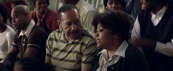 Movie still from “Woodlawn” (2015), directed by Jon Erwin – A man and a woman sitting next to each other; Close Up shot, Over the shoulder angle