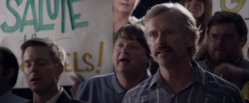 Movie still from “Woodlawn” (2015), directed by Jon Erwin – Two men are standing in front of a protest sign; Close Up shot, Over the shoulder angle