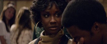 Movie still from “Woodlawn” (2015), directed by Jon Erwin – A person wearing a sweater and a necklace; Close Up shot, Over the shoulder angle