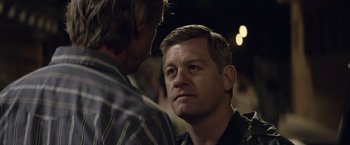 Movie still from “Woodlawn” (2015), directed by Jon Erwin – Two men are talking to each other in the dark; Close Up shot, Over the shoulder angle