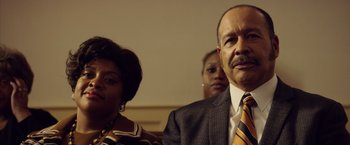 Movie still from “Woodlawn” (2015), directed by Jon Erwin – A man and a woman standing next to each other in a room; Close Up shot, Low angle