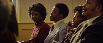 Movie still from “Woodlawn” (2015), directed by Jon Erwin – A man and a woman are standing next to each other; Medium shot, Over the shoulder angle