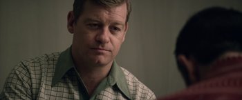 Movie still from “Woodlawn” (2015), directed by Jon Erwin – A person wearing a green and white shirt; Close Up shot, Over the shoulder angle
