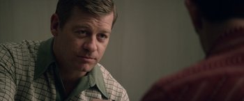 Movie still from “Woodlawn” (2015), directed by Jon Erwin – A person wearing a checkered shirt; Close Up shot, Over the shoulder angle