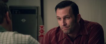 Movie still from “Woodlawn” (2015), directed by Jon Erwin – A person sitting in a room; Close Up shot, Over the shoulder angle