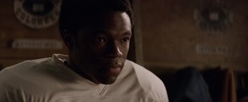 Movie still from “Woodlawn” (2015), directed by Jon Erwin – A person wearing a white shirt; Close Up shot, Over the shoulder angle