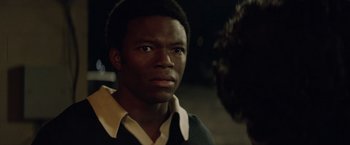 Movie still from “Woodlawn” (2015), directed by Jon Erwin – A person wearing a shirt and tie; Close Up shot, Over the shoulder angle