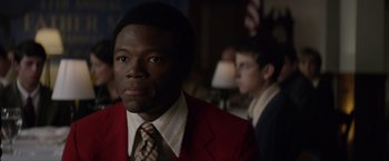 Movie still from “Woodlawn” (2015), directed by Jon Erwin – A person wearing a suit and a tie; Close Up shot, Over the shoulder angle