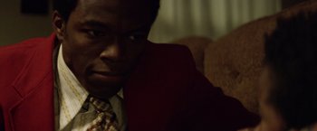 Movie still from “Woodlawn” (2015), directed by Jon Erwin – A person wearing a suit and tie; Close Up shot, High angle