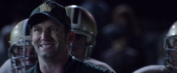 Movie still from “Woodlawn” (2015), directed by Jon Erwin – A football player wearing a helmet; Close Up shot, Over the shoulder angle