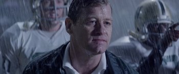 Movie still from “Woodlawn” (2015), directed by Jon Erwin – A person in the rain; Close Up shot, Over the shoulder angle