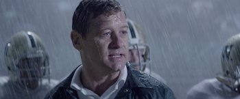 Movie still from “Woodlawn” (2015), directed by Jon Erwin – A football player in the rain; Close Up shot, Low angle