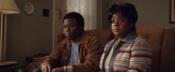 Movie still from “Woodlawn” (2015), directed by Jon Erwin – A man and a woman sitting on a couch; Medium shot, Over the shoulder angle