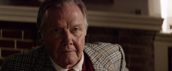 Movie still from “Woodlawn” (2015), directed by Jon Erwin – An older man wearing a suit and tie; Close Up shot, Over the shoulder angle