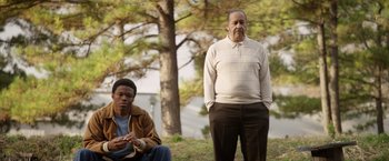 Movie still from “Woodlawn” (2015), directed by Jon Erwin – Two men standing next to each other on a hill; Medium shot, Low angle
