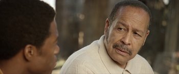 Movie still from “Woodlawn” (2015), directed by Jon Erwin – An older man is talking to a younger man; Close Up shot, Over the shoulder angle