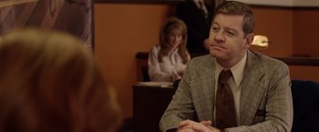 Movie still from “Woodlawn” (2015), directed by Jon Erwin – A man sitting at a table in front of a woman; Medium shot, Over the shoulder angle