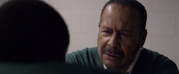 Movie still from “Woodlawn” (2015), directed by Jon Erwin – An older man sitting in front of another man; Close Up shot, Over the shoulder angle