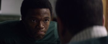 Movie still from “Woodlawn” (2015), directed by Jon Erwin – A man looking at himself in the mirror; Close Up shot, Over the shoulder angle