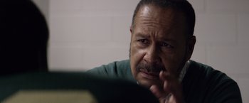 Movie still from “Woodlawn” (2015), directed by Jon Erwin – An older man sitting in front of a computer screen; Close Up shot, Over the shoulder angle