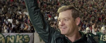 Movie still from “Woodlawn” (2015), directed by Jon Erwin – A person holding up his hand; Medium shot, Low angle