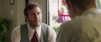 Movie still from “Woodlawn” (2015), directed by Jon Erwin – A man wearing a vest and tie talking to another man; Close Up shot, Over the shoulder angle
