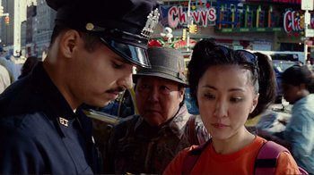 Movie still from “World Trade Center” (2006), directed by Oliver Stone – A man and a woman are standing next to a man in uniform; Close Up shot, Over the shoulder angle