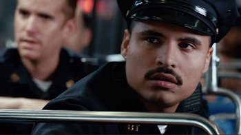 Movie still from “World Trade Center” (2006), directed by Oliver Stone – A man in a police uniform sitting on a bus; Close Up shot, Low angle