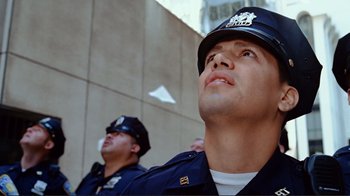 Movie still from “World Trade Center” (2006), directed by Oliver Stone – Two police officers are standing next to each other; Close Up shot, Low angle