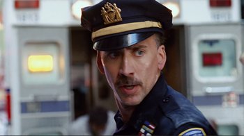 Movie still from “World Trade Center” (2006), directed by Oliver Stone – A man in a police officer's uniform with a serious look on his face; Close Up shot, Low angle