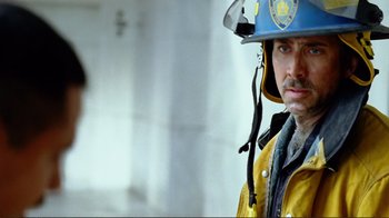 Movie still from “World Trade Center” (2006), directed by Oliver Stone – A man in a fireman's uniform with a helmet on his head; Close Up shot, Low angle