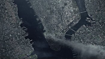 Movie still from “World Trade Center” (2006), directed by Oliver Stone – An aerial view of a large city with smoke billowing out of it; Extreme Wide shot, Overhead angle