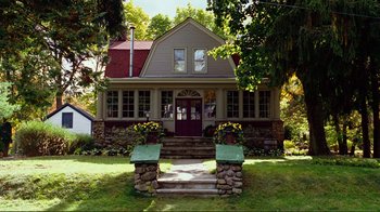 Movie still from “World Trade Center” (2006), directed by Oliver Stone – A house sitting on the side of a river; Wide shot, Low angle