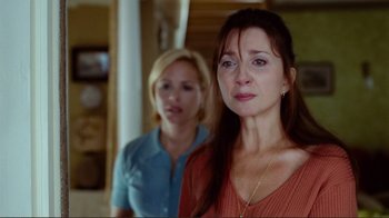 Movie still from “World Trade Center” (2006), directed by Oliver Stone – Two women standing next to each other in a room; Close Up shot, Over the shoulder angle