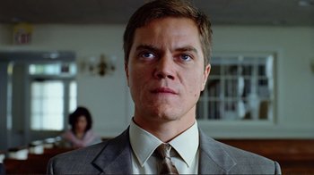 Movie still from “World Trade Center” (2006), directed by Oliver Stone – A person wearing a suit and tie; Close Up shot, Low angle