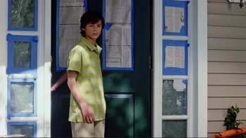 Movie still from “World Trade Center” (2006), directed by Oliver Stone – A young man standing in front of a door; Medium shot, Low angle