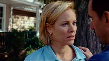 Movie still from “World Trade Center” (2006), directed by Oliver Stone – A woman with blonde hair wearing a light blue shirt; Close Up shot, Over the shoulder angle