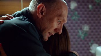 Movie still from “World Trade Center” (2006), directed by Oliver Stone – A person looking down at a woman; Close Up shot, Over the shoulder angle