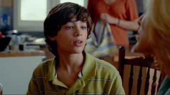 Movie still from “World Trade Center” (2006), directed by Oliver Stone – A young man in a yellow shirt is sitting in front of a woman in an orange shirt; Close Up shot, Over the shoulder angle