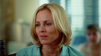Movie still from “World Trade Center” (2006), directed by Oliver Stone – A woman with blonde hair wearing a blue shirt looking to her left; Close Up shot, Over the shoulder angle
