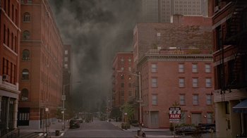 Movie still from “World Trade Center” (2006), directed by Oliver Stone – Smoke billows from a building on a city street; Extreme Wide shot, High angle
