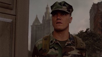 Movie still from “World Trade Center” (2006), directed by Oliver Stone – A man in a military uniform standing in front of a building; Medium shot, Low angle