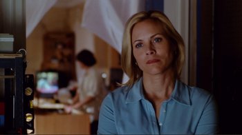 Movie still from “World Trade Center” (2006), directed by Oliver Stone – A woman in a blue shirt is looking at the camera; Close Up shot, Over the shoulder angle