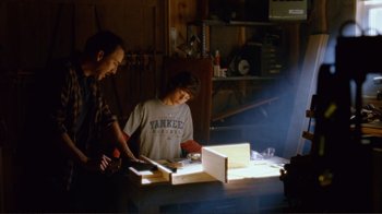 Movie still from “World Trade Center” (2006), directed by Oliver Stone – Two men working in a wood working shop; Medium shot, Low angle