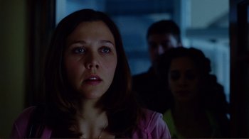 Movie still from “World Trade Center” (2006), directed by Oliver Stone – A young woman is staring at the camera; Close Up shot, Over the shoulder angle