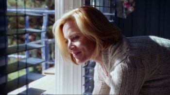 A woman sitting in front of a window