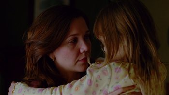 Movie still from “World Trade Center” (2006), directed by Oliver Stone – A woman holding a little girl in her arms; Close Up shot, Over the shoulder angle